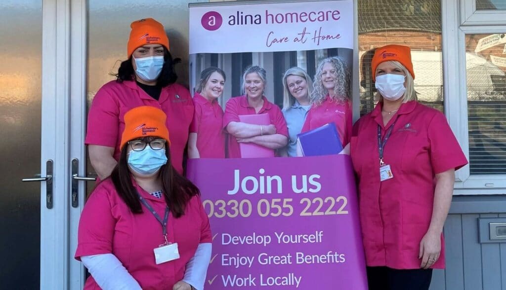 Care workers smiling outside Alina Homecare Hereford